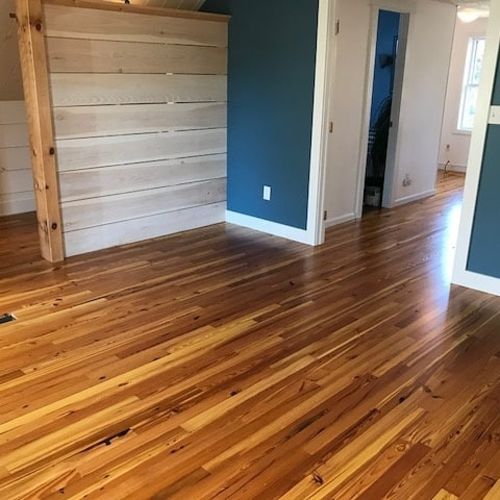A living room with hardwood floors and blue walls.