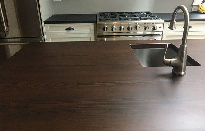 A kitchen with a sink and stove top oven