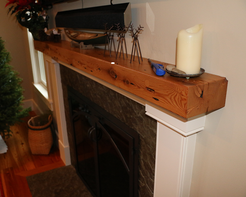 A fireplace with a wooden mantle and a candle on it