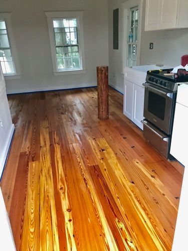 A kitchen with hardwood floors and a stove.