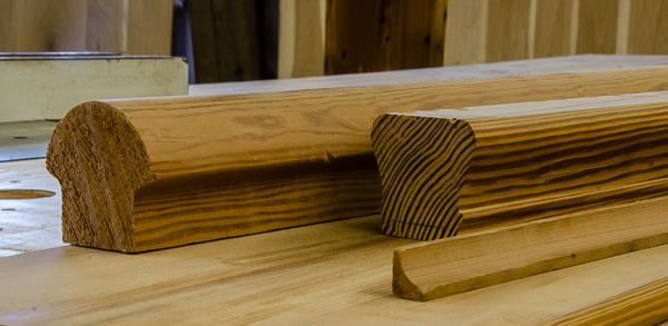 A wooden railing is sitting on top of a wooden table.