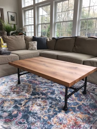 A living room with a couch and a coffee table.