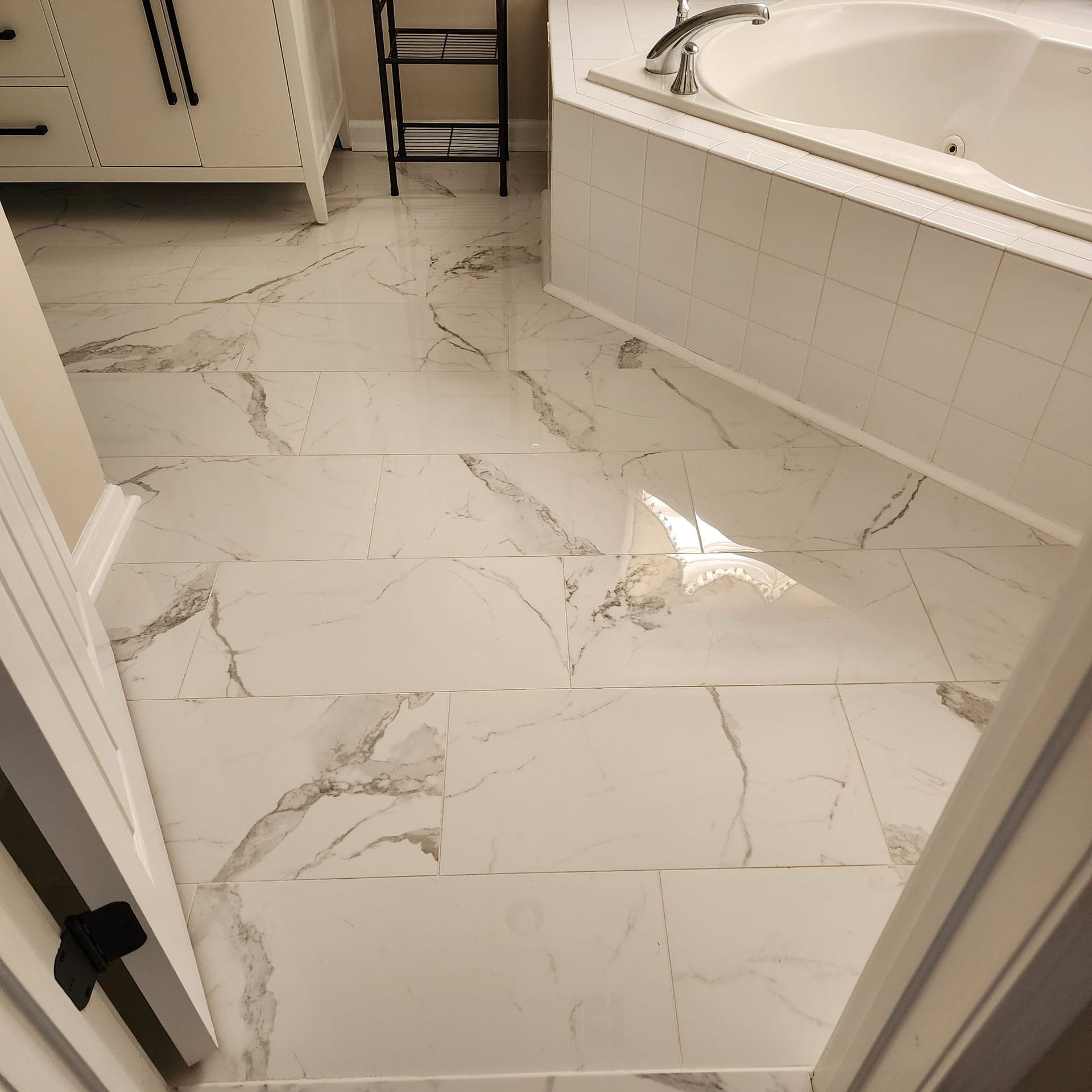 A bathroom with marble floors and a bathtub