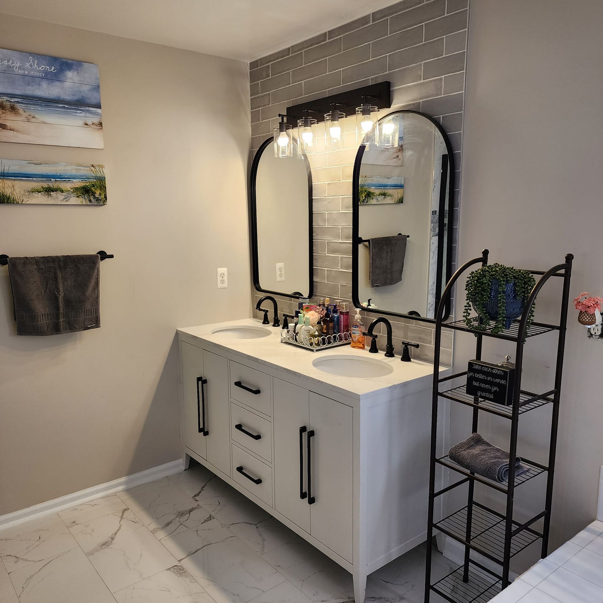 A bathroom with two sinks and two mirrors