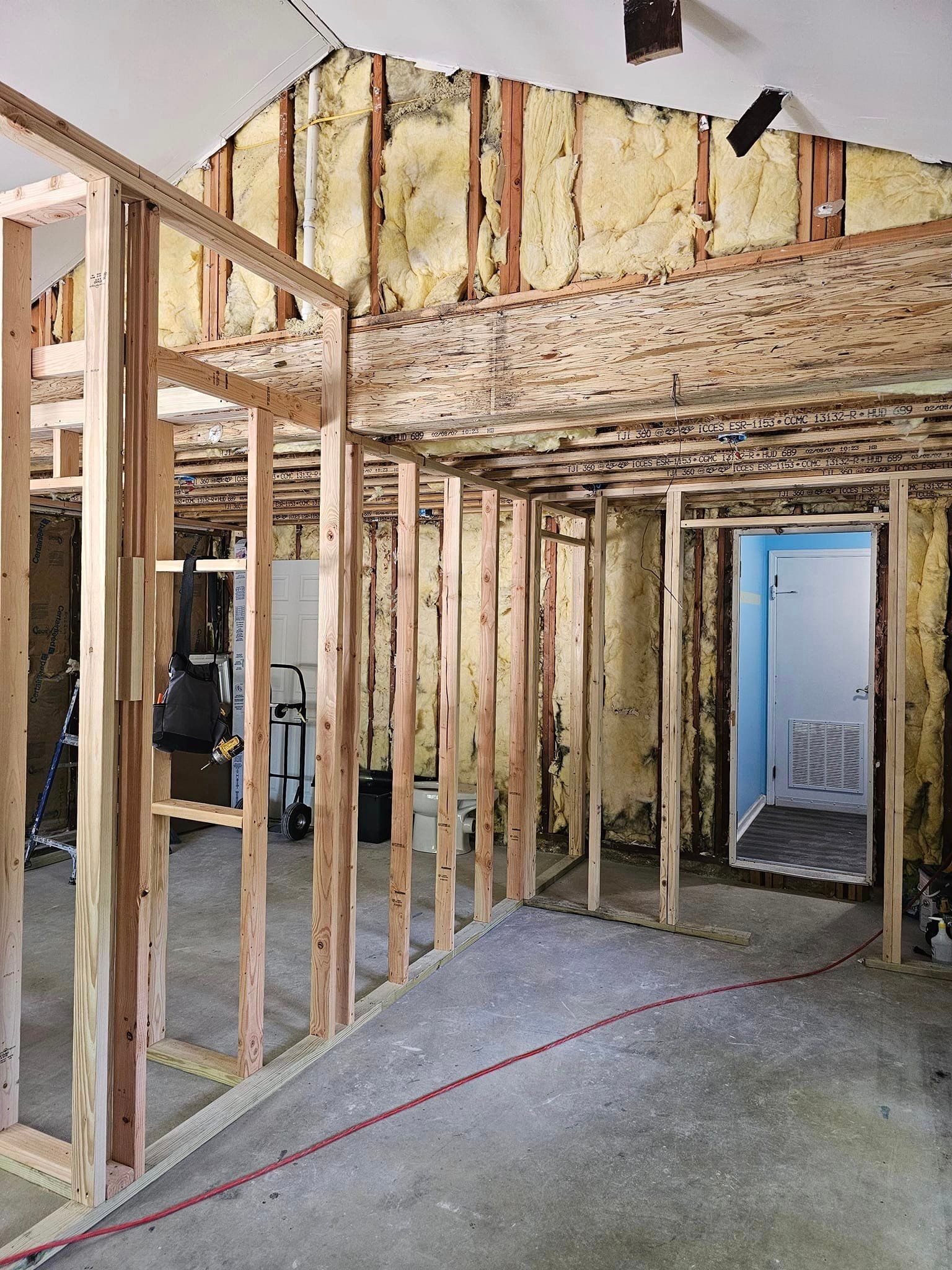 A room with a lot of wooden frames and a door.