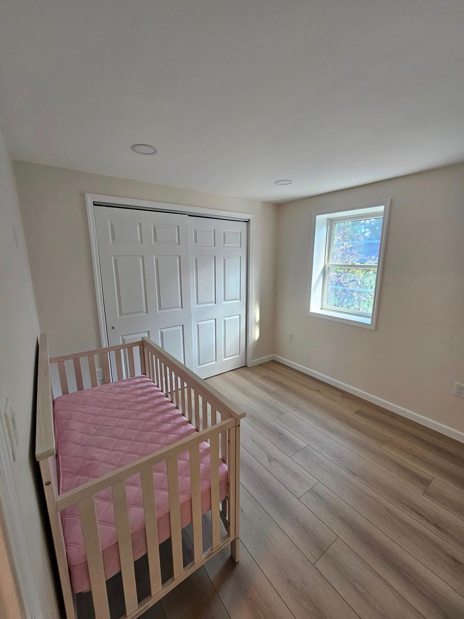 There is a crib in the middle of the room.