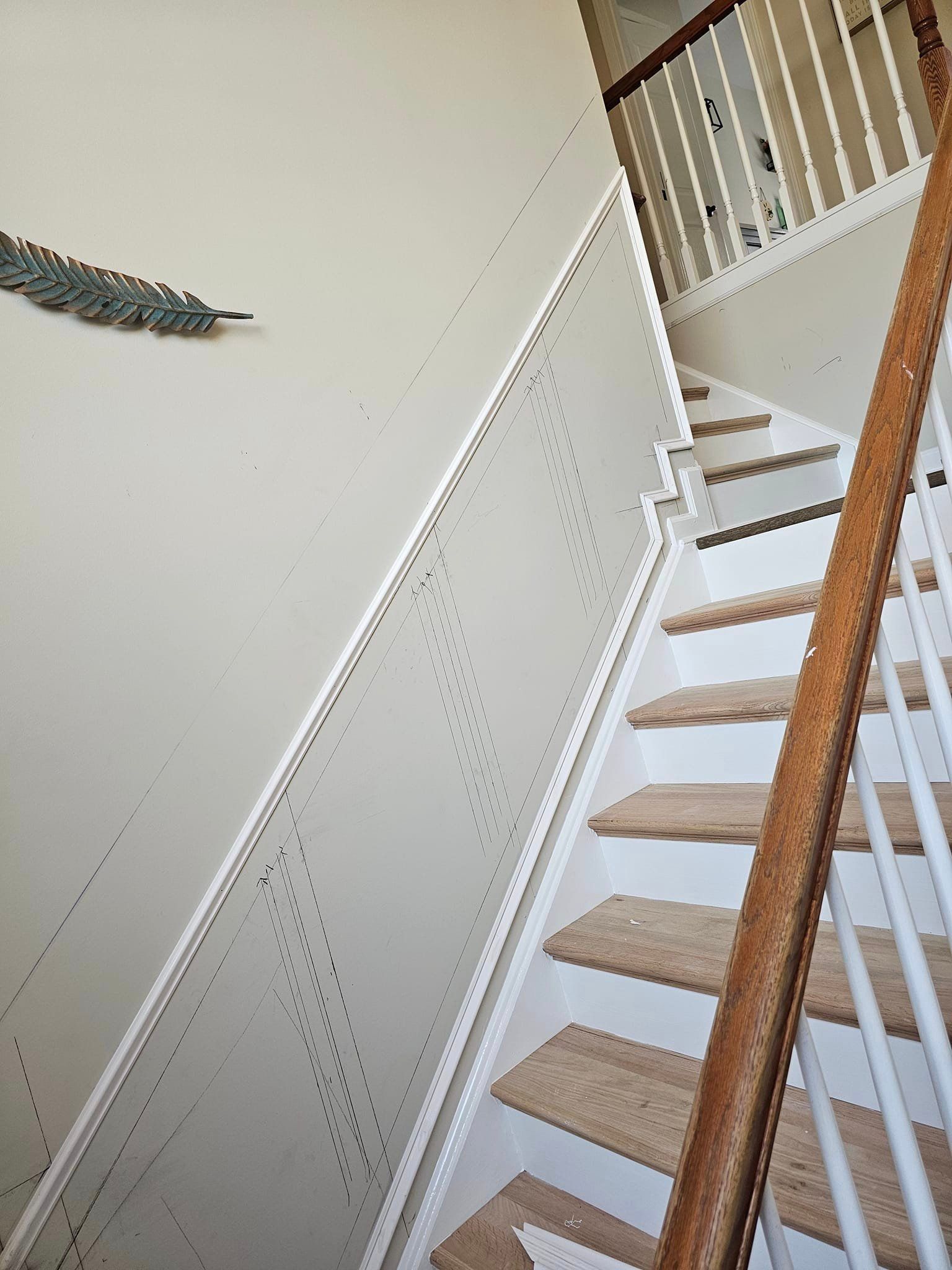 A staircase with a wooden railing and carpeted steps in a house.