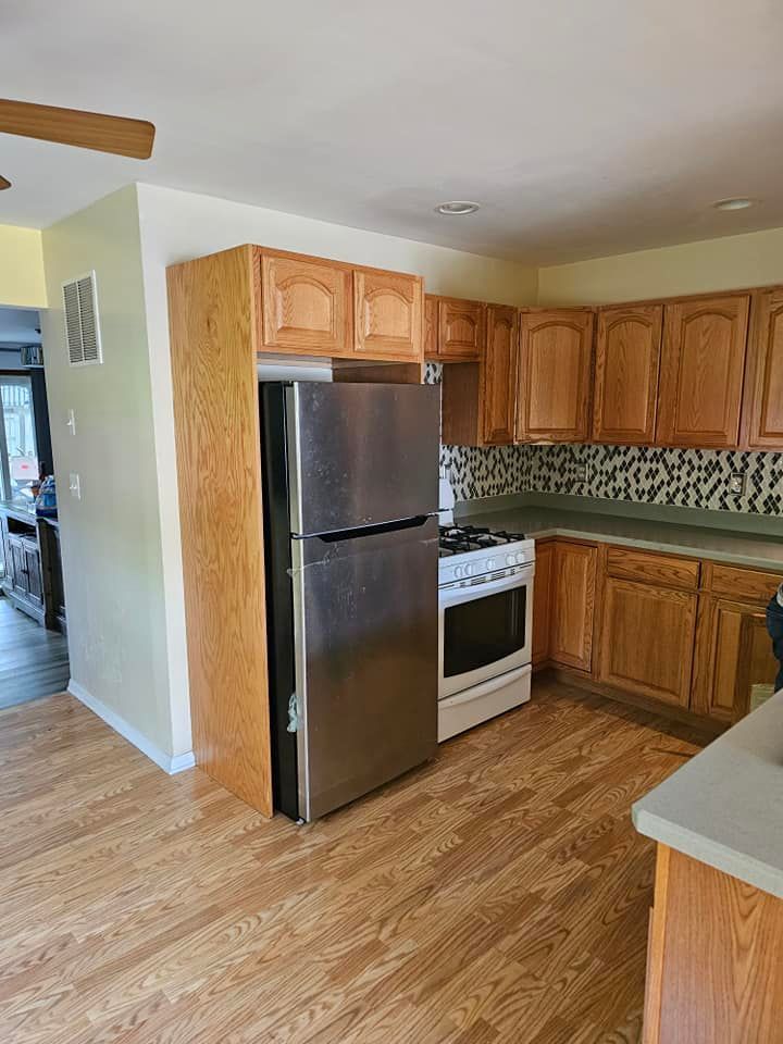 A kitchen with stainless steel appliances and wooden cabinets.