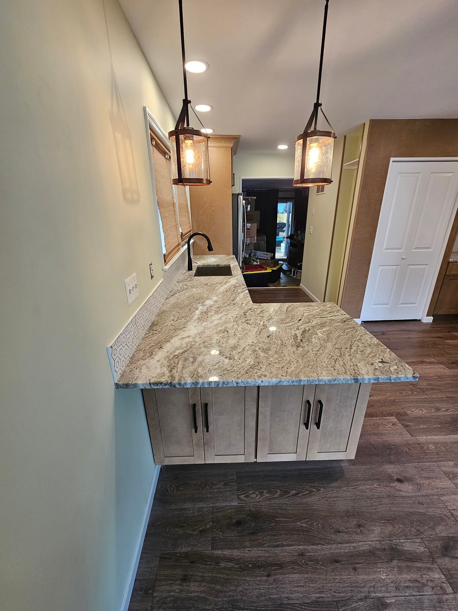 A kitchen with granite counter tops and a sink.