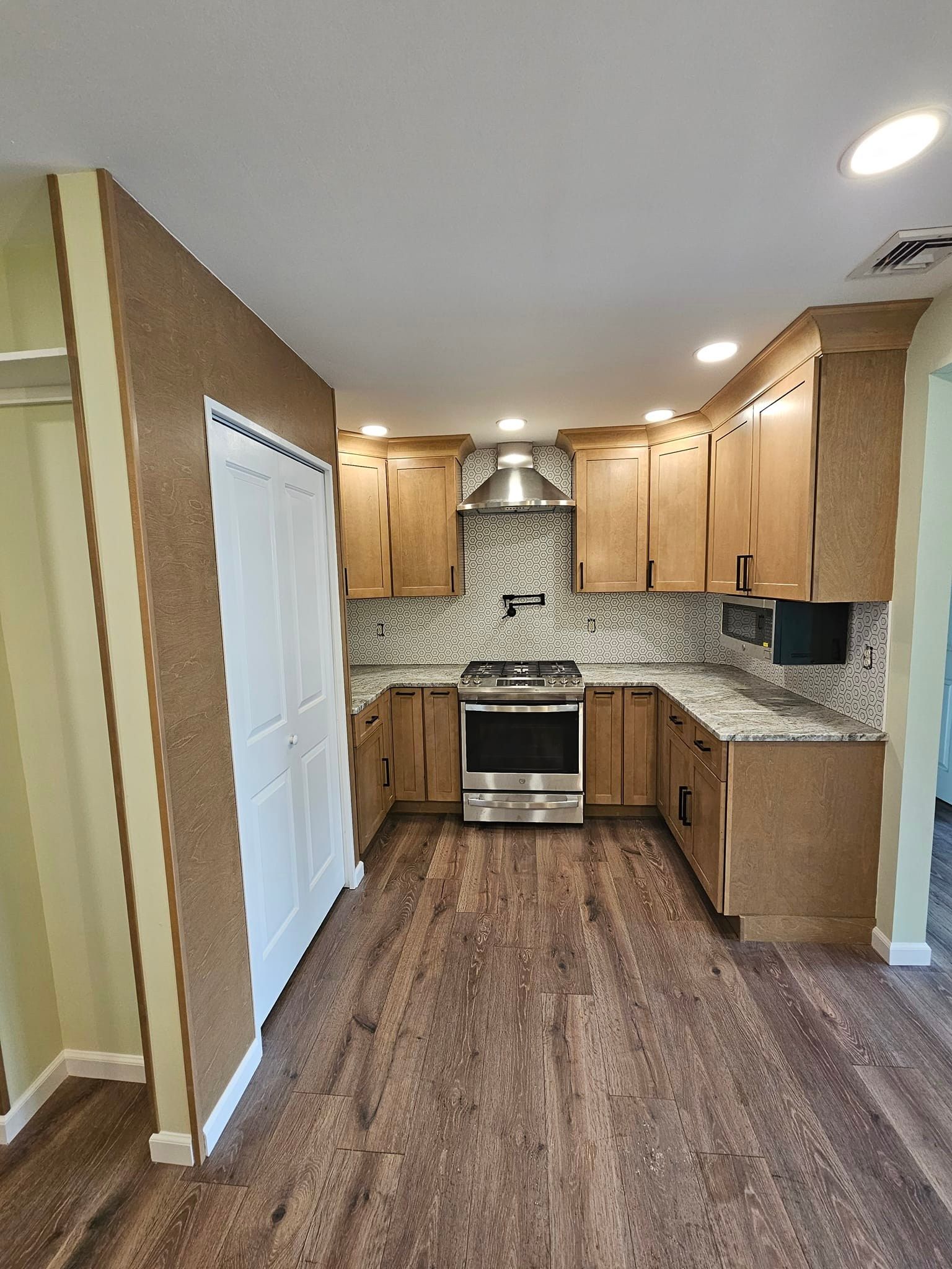 A kitchen with wooden cabinets and stainless steel appliances.