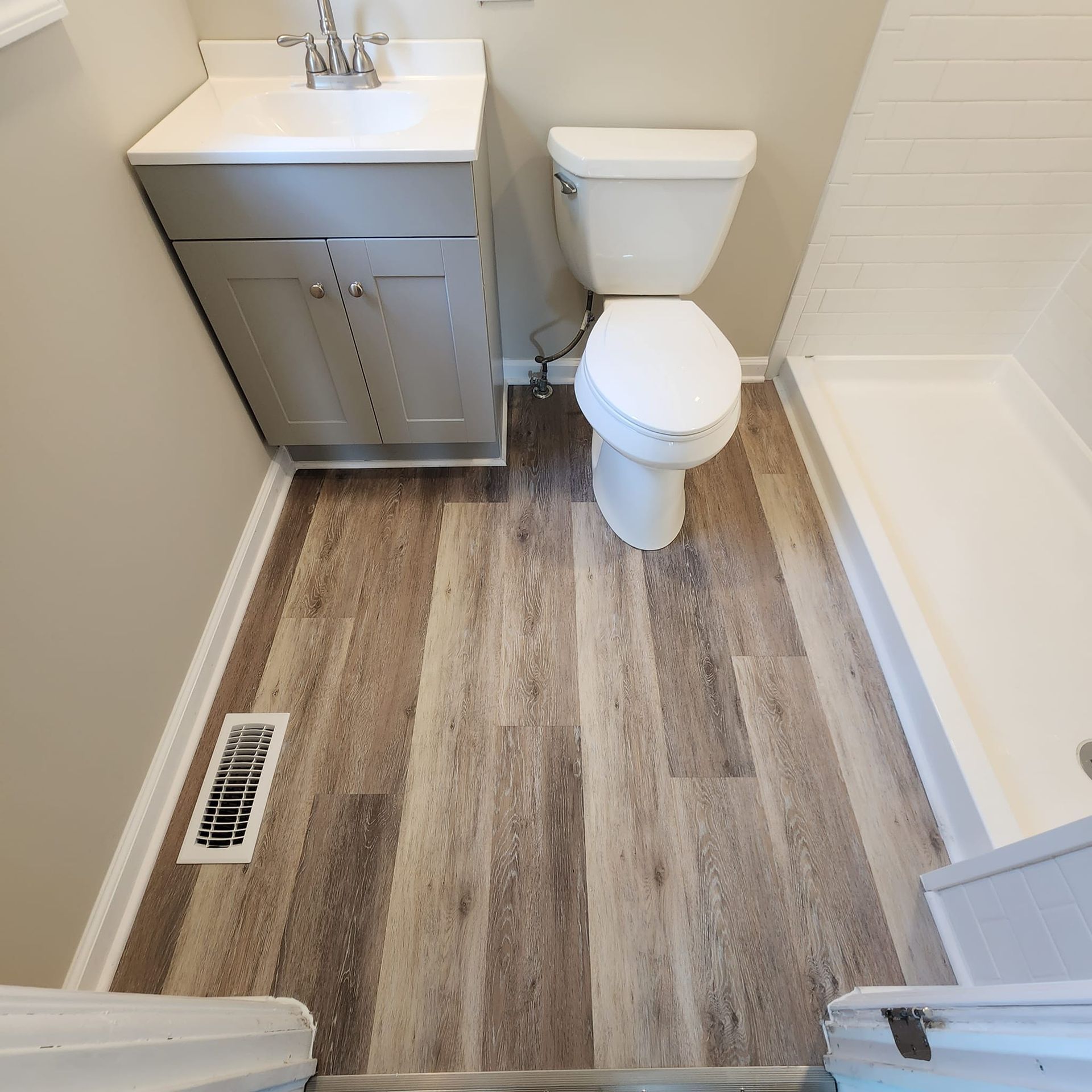 A bathroom with a toilet a sink and a shower
