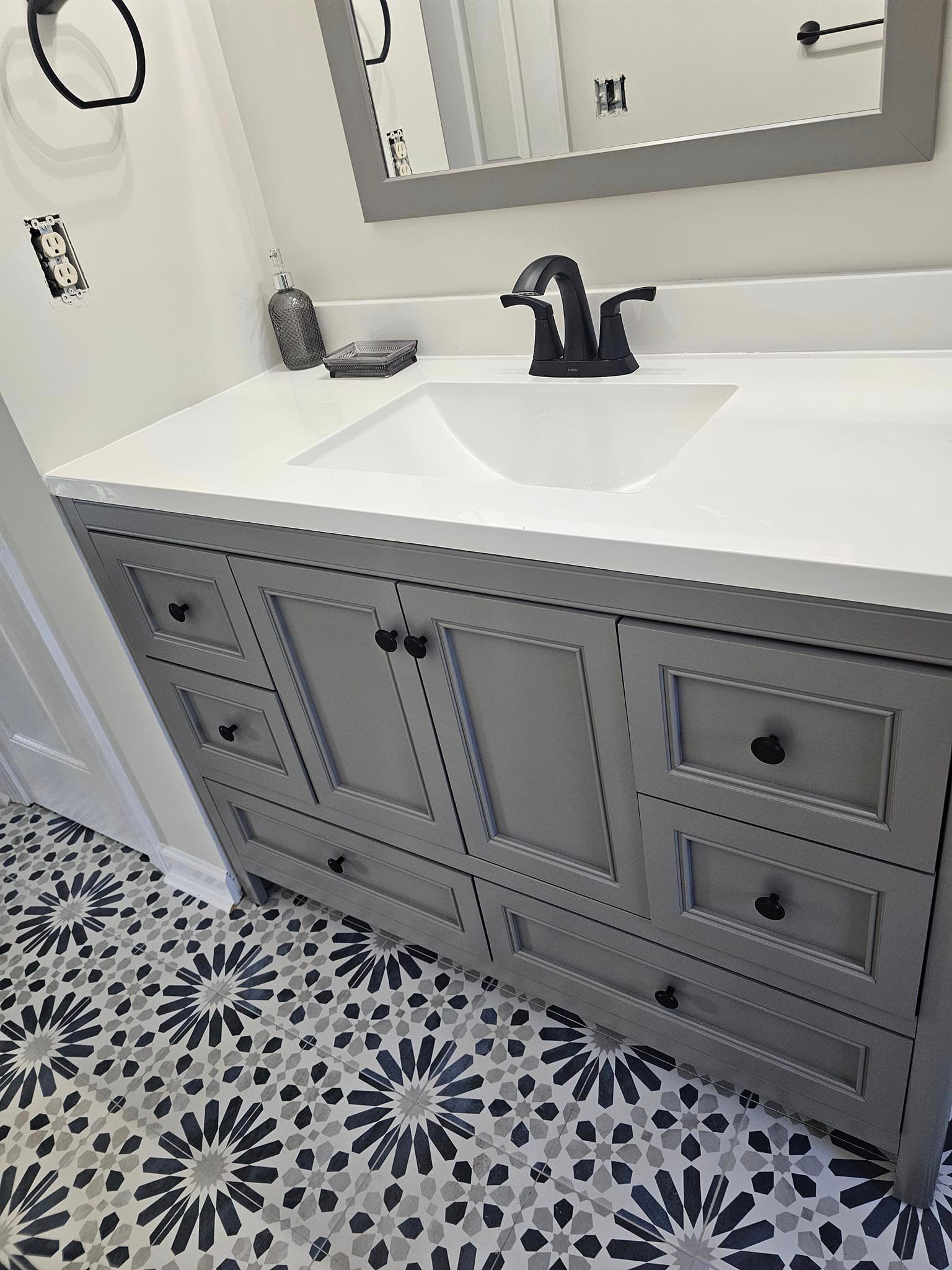 A bathroom vanity with a sink and a mirror.