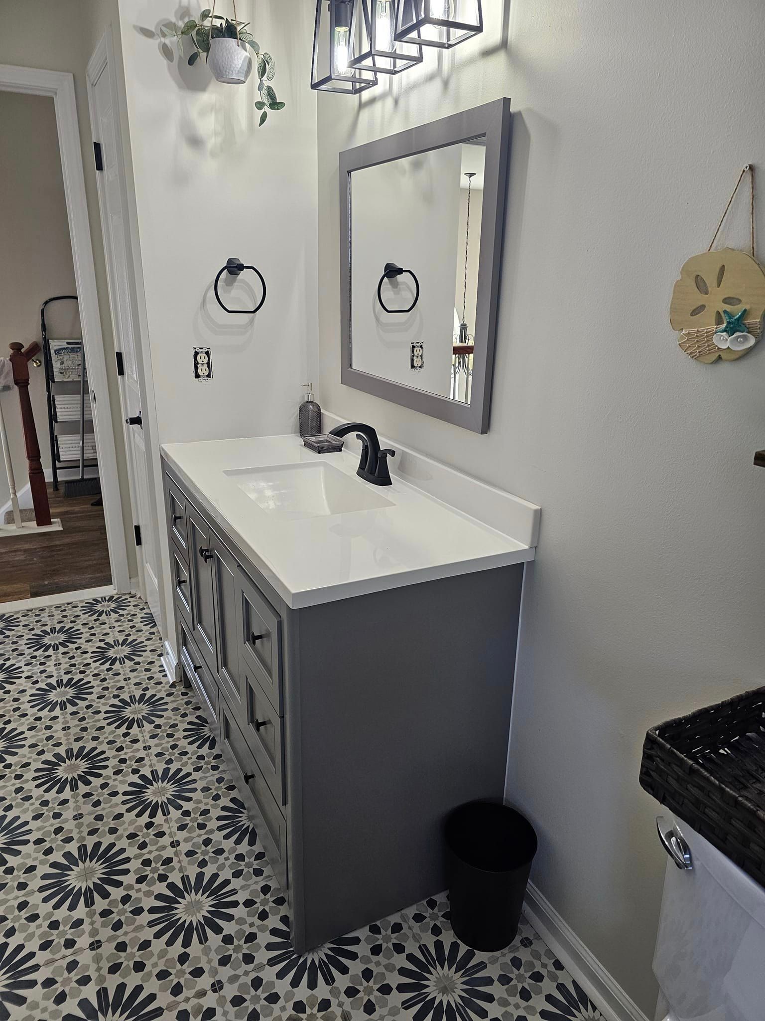 A bathroom with a sink, mirror and toilet.