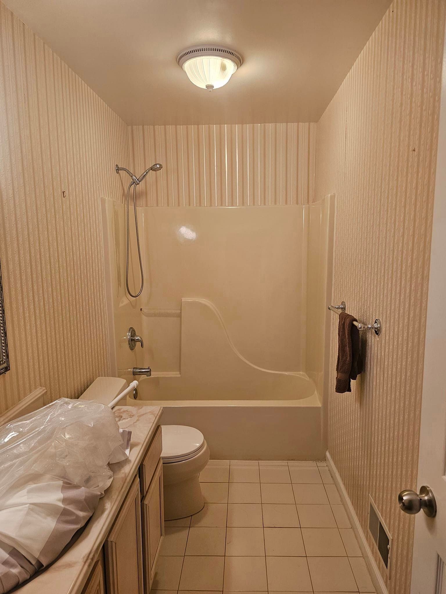 A bathroom with a toilet, sink, tub and shower.