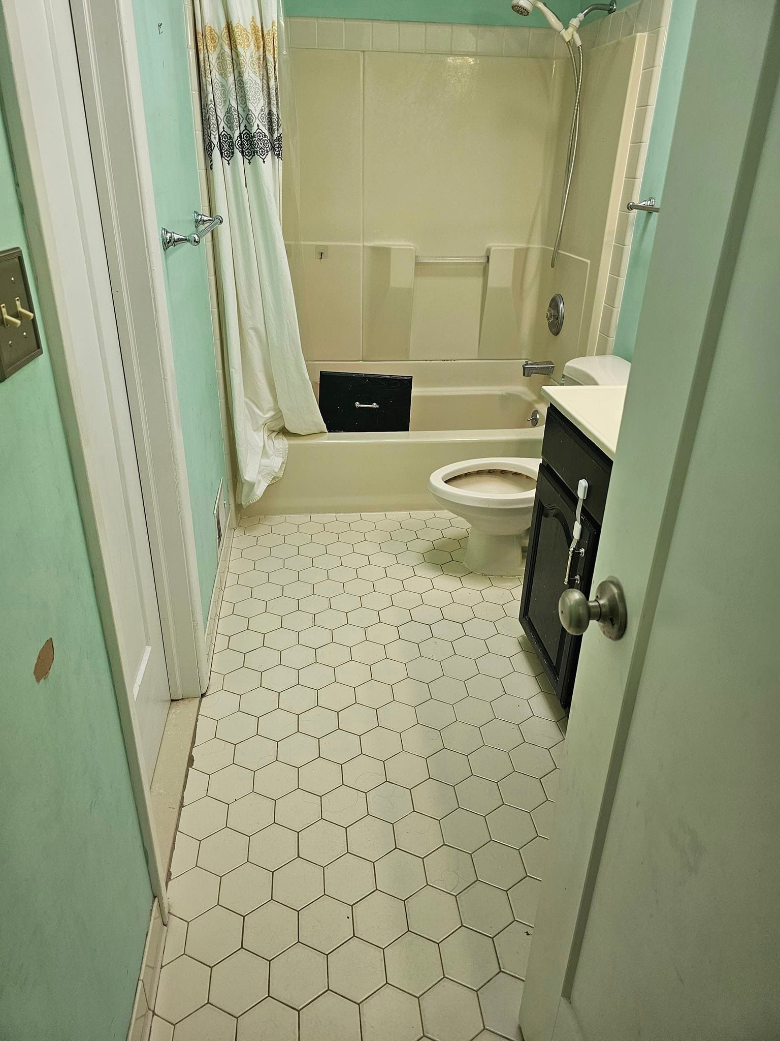 A bathroom with a toilet, sink, tub and shower.