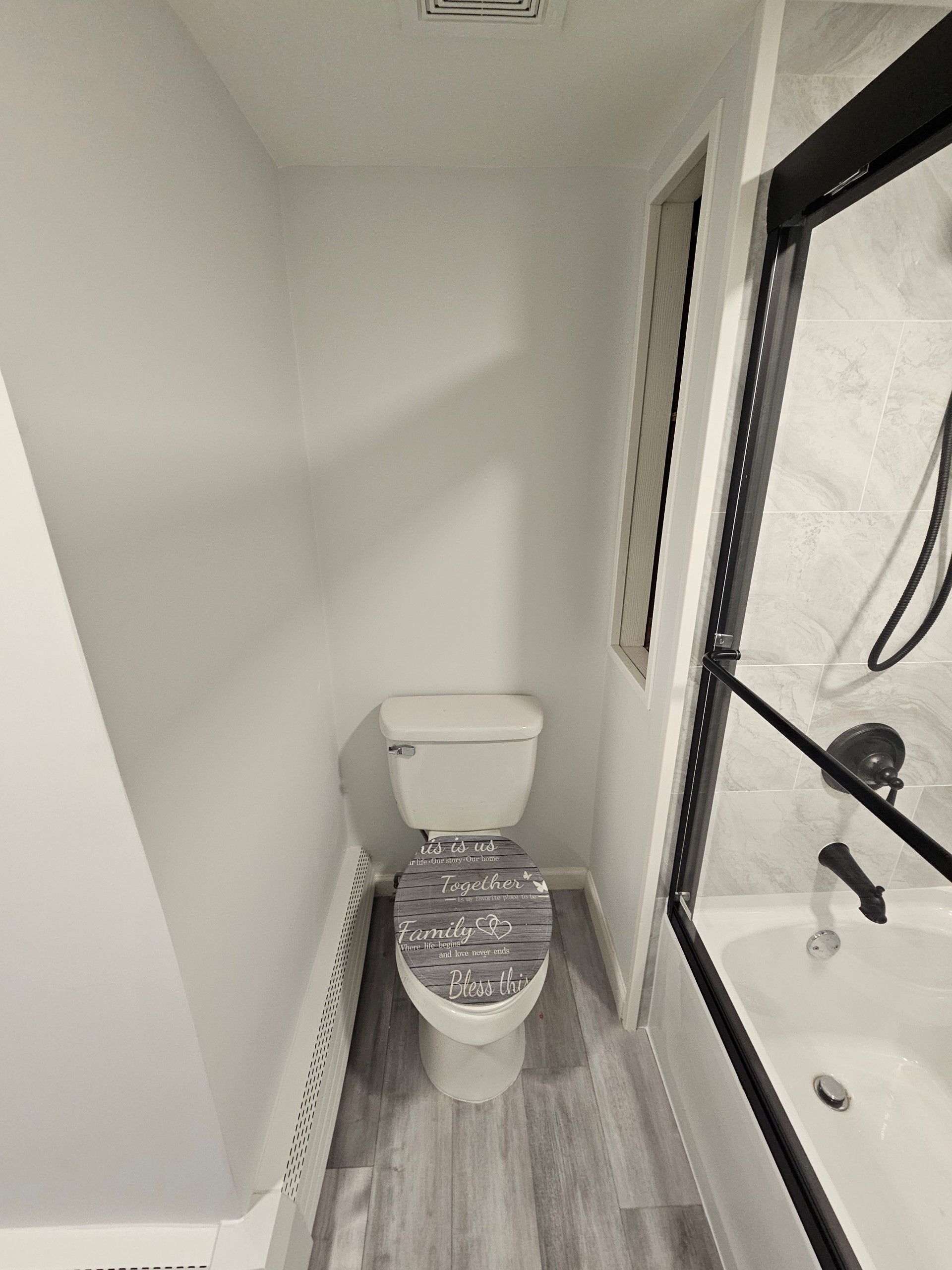 A bathroom with a toilet, sink, and shower.