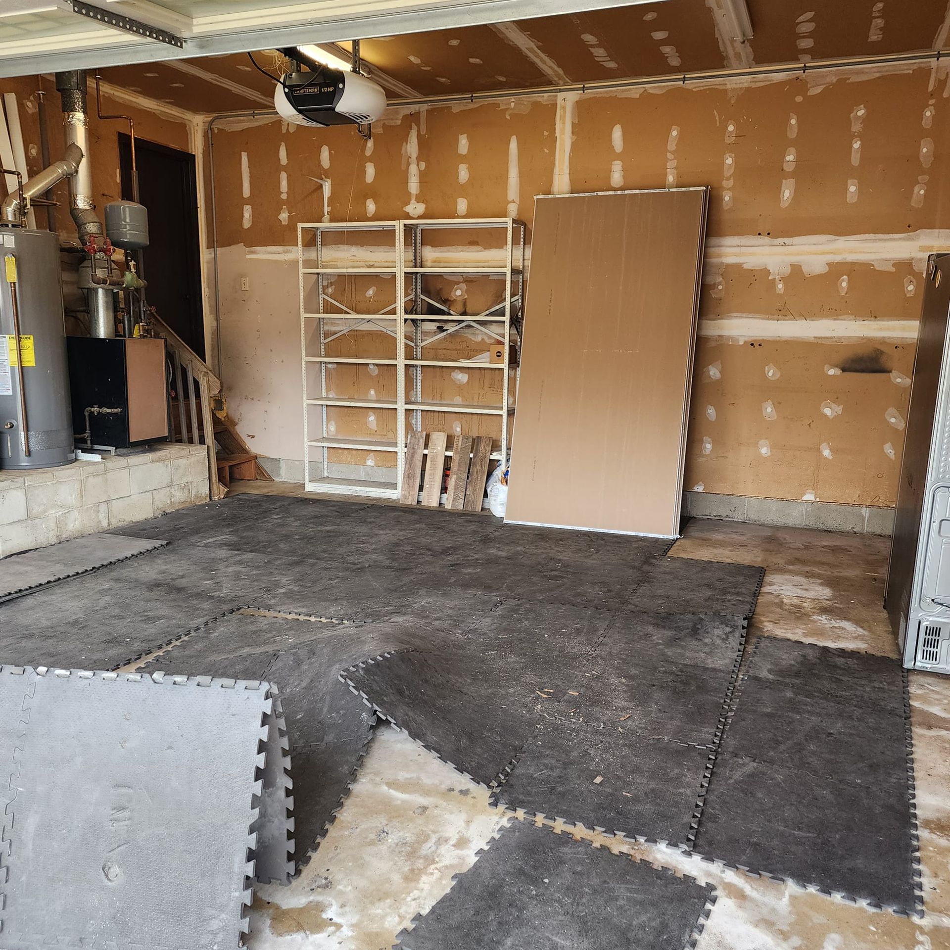 A garage with a lot of pieces of carpet on the floor