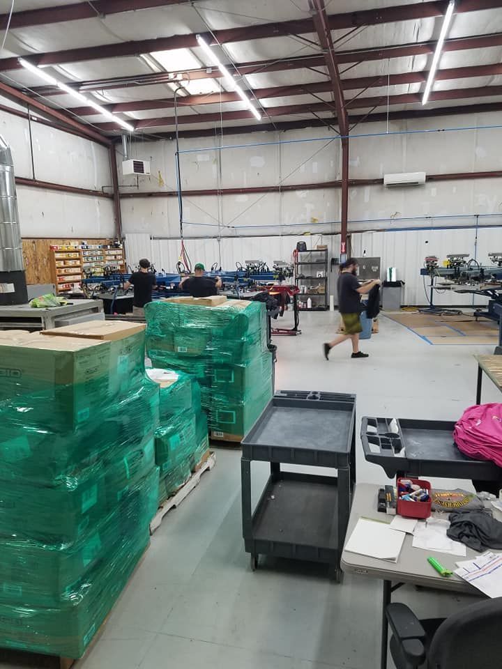 A large warehouse filled with lots of boxes and carts.