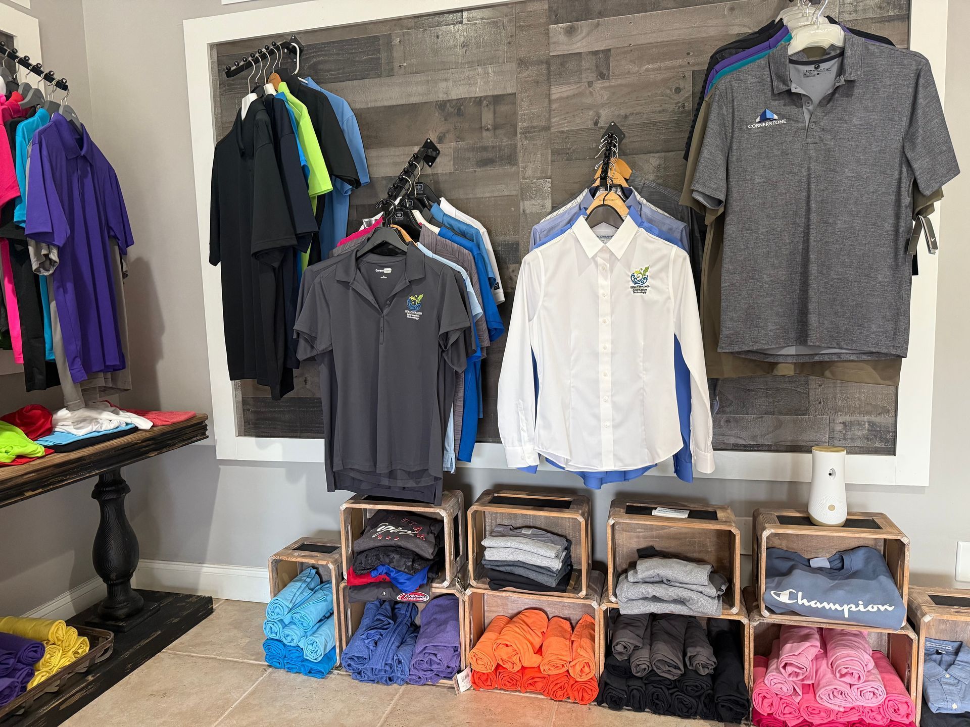 A room filled with lots of shirts hanging on a wall.