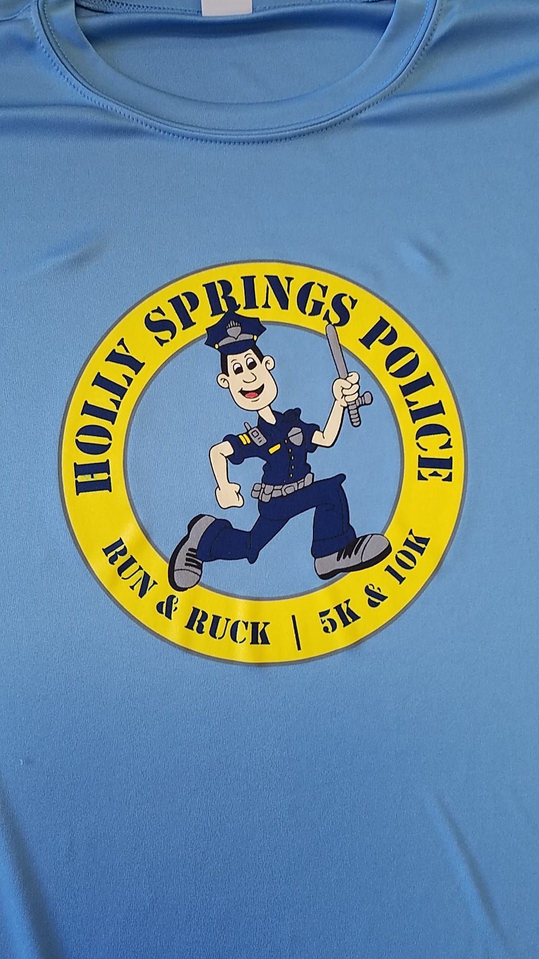 A blue shirt with a picture of a police officer on it.