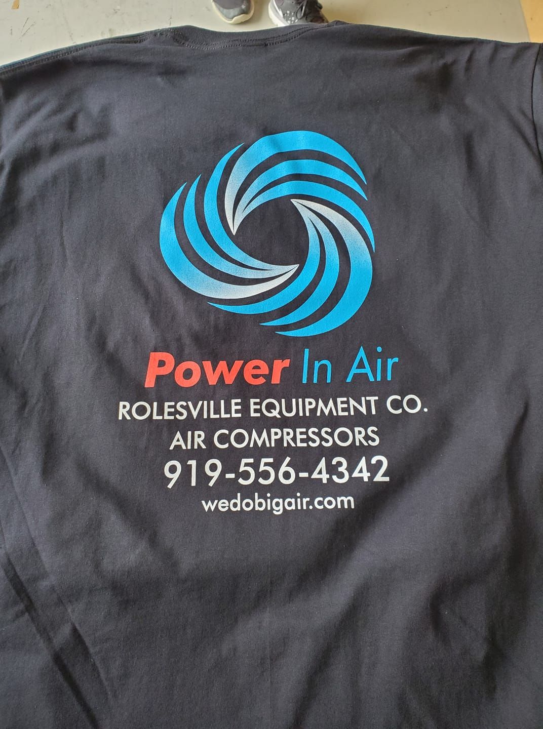 A black t-shirt that says power in air on it
