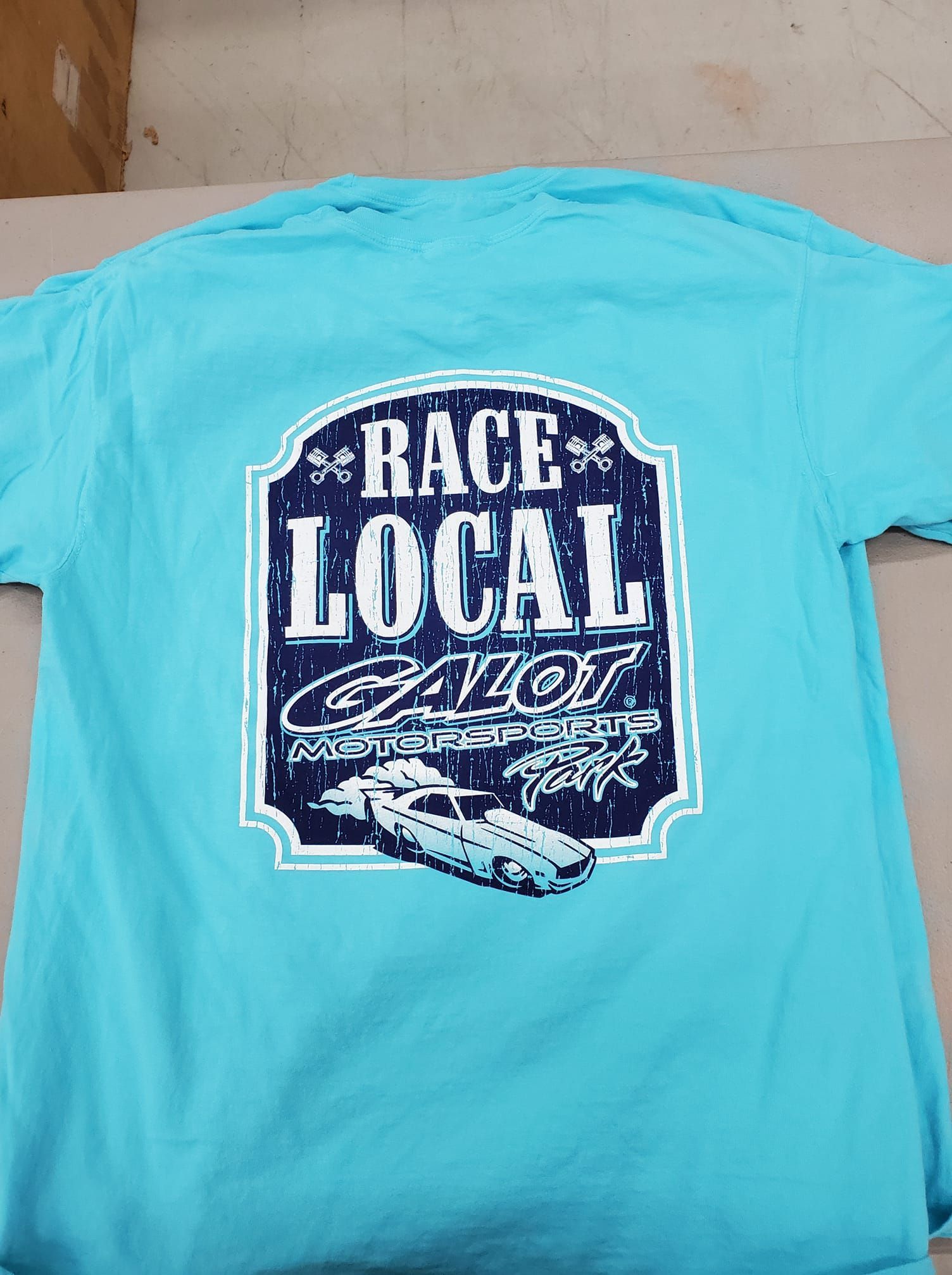 A blue t-shirt with the words race local on it