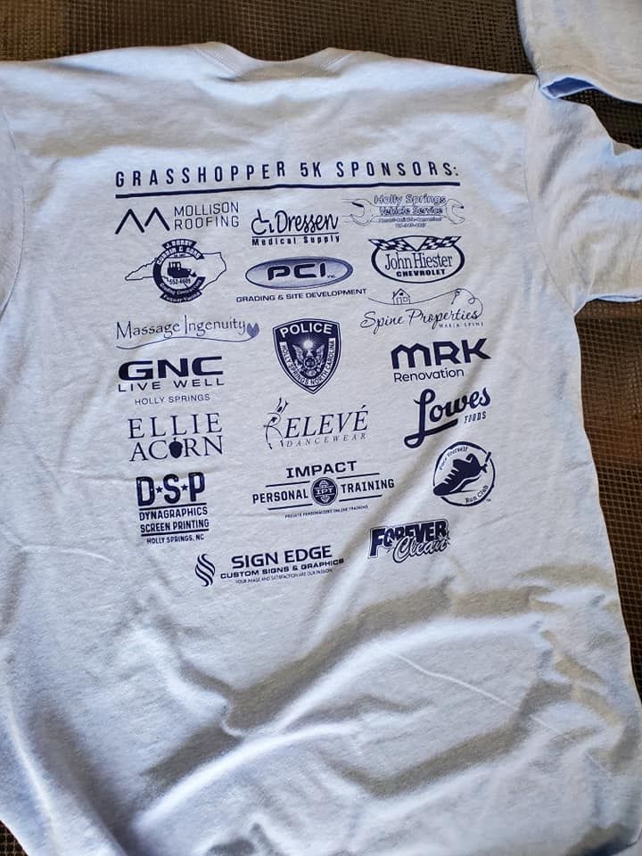 A white t-shirt with a lot of logos on it