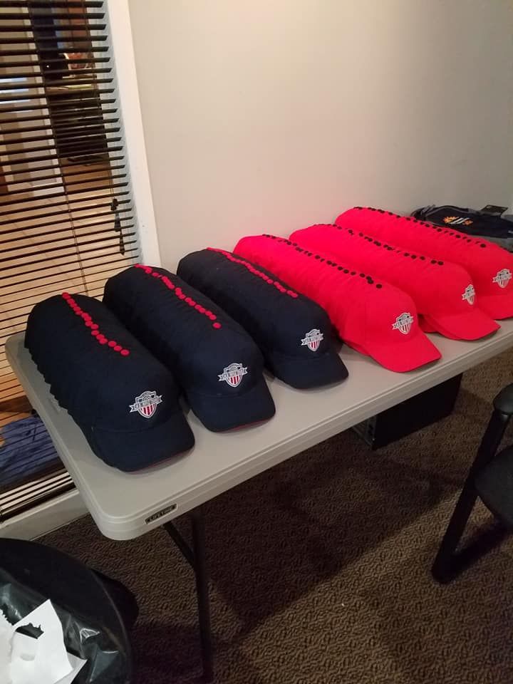 A table with a bunch of hats on it