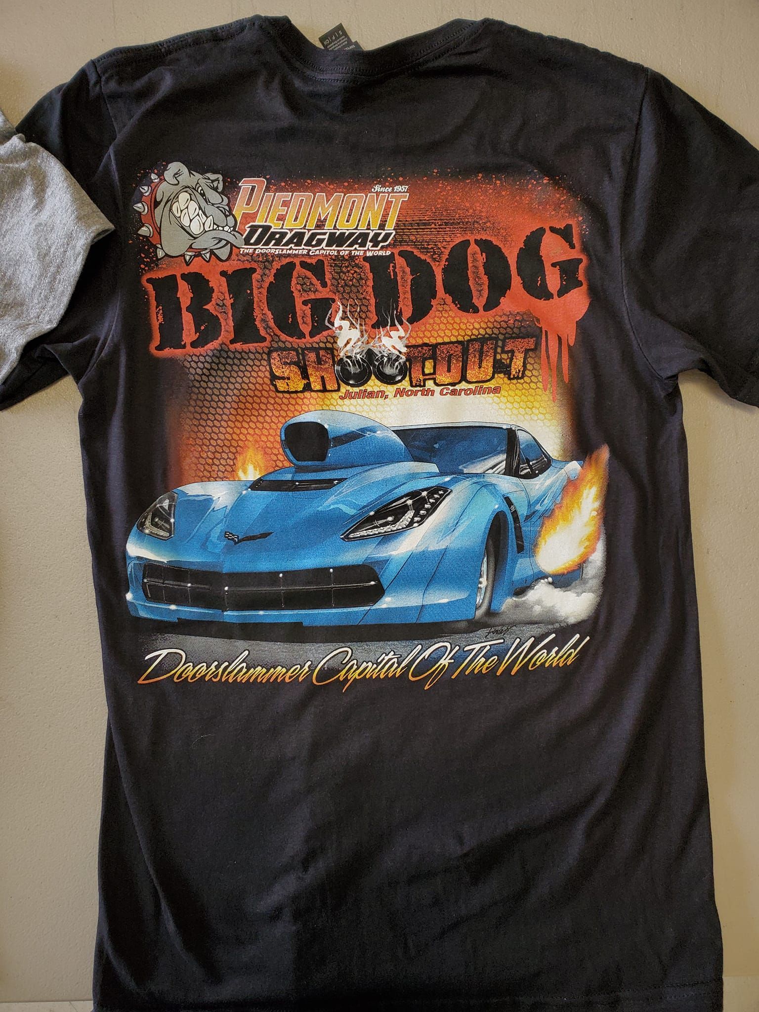 A black t-shirt with a blue car on it that says big dog
