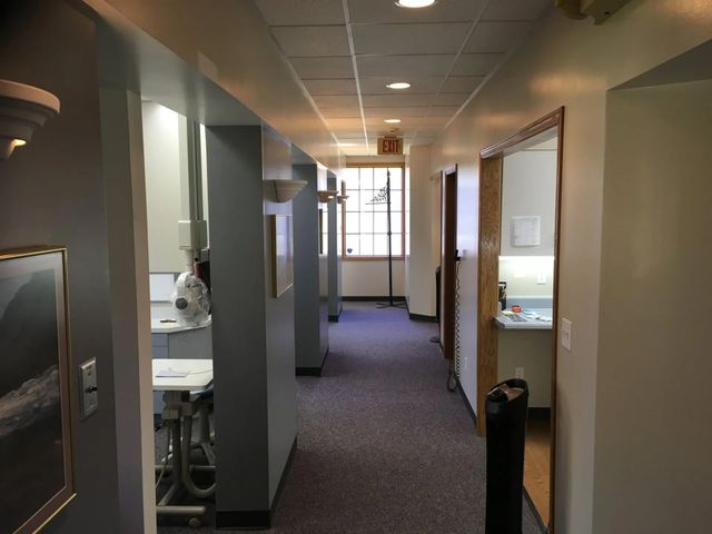 Hallway in office building; doors and windows visible.