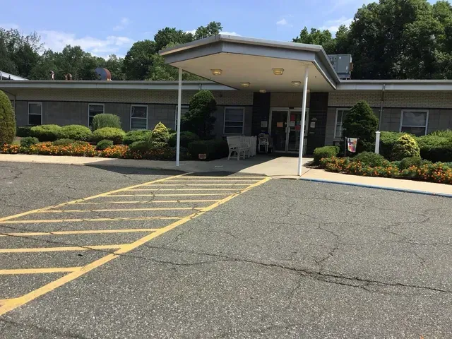 A large building with a parking lot in front of it