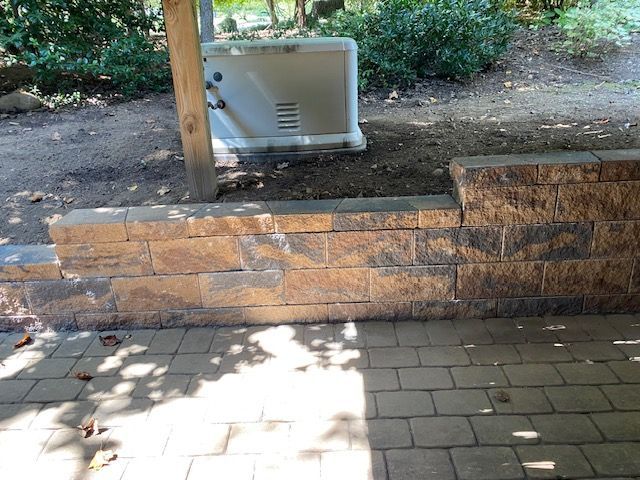 A brick wall with a white box on top of it