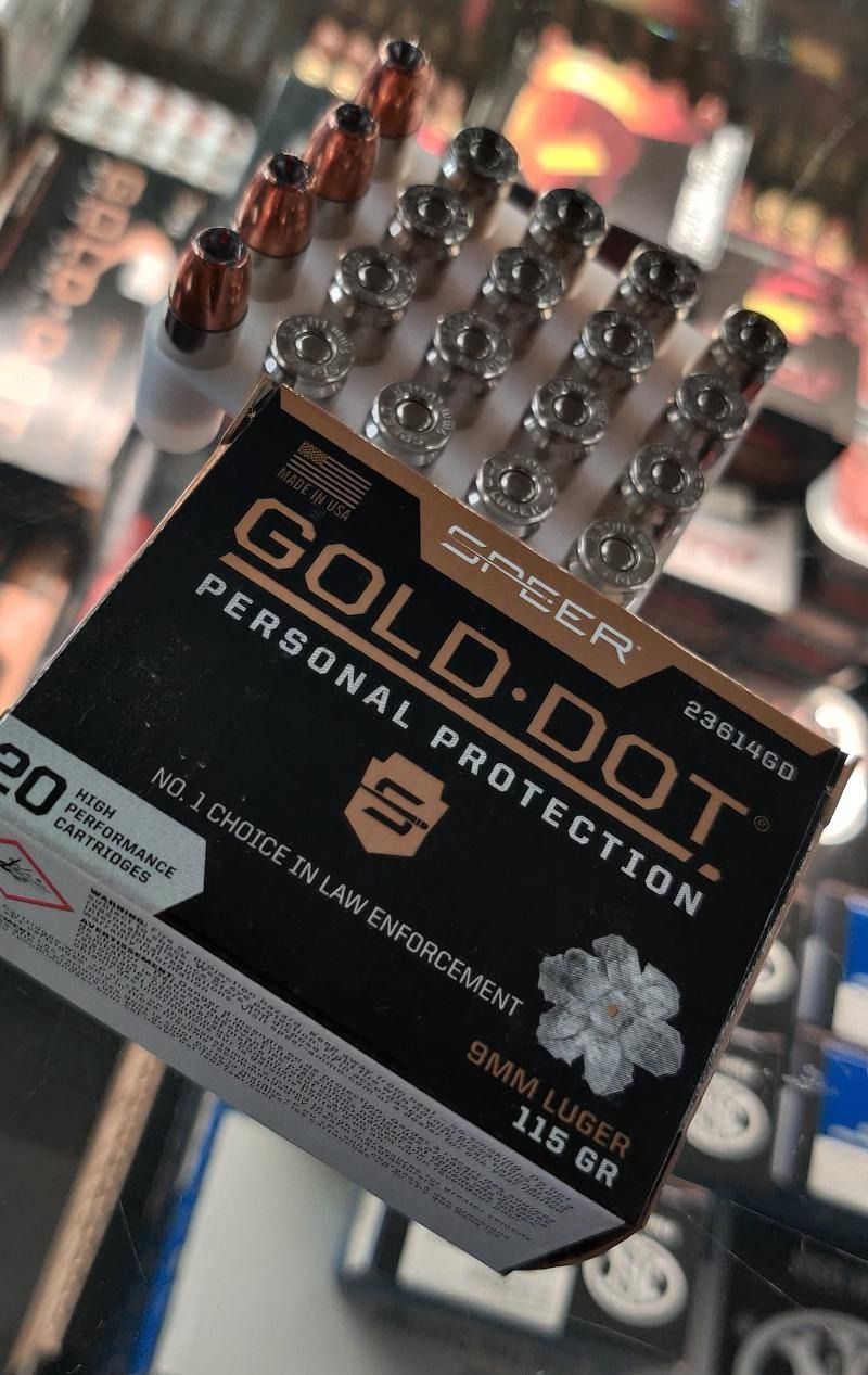 A box of gold dot personal protection bullets is sitting on a table.