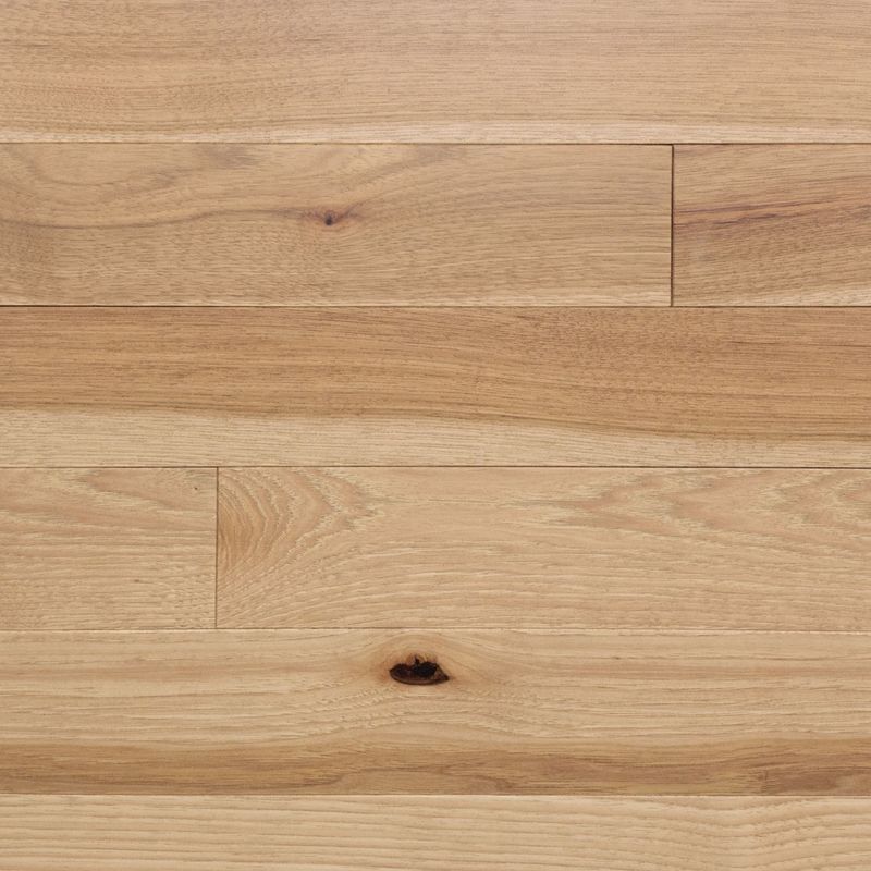 A close up of a wooden floor with a hole in it.