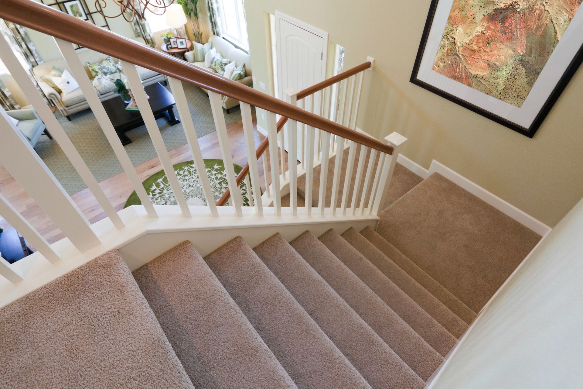 The stairs are carpeted and have a wooden railing