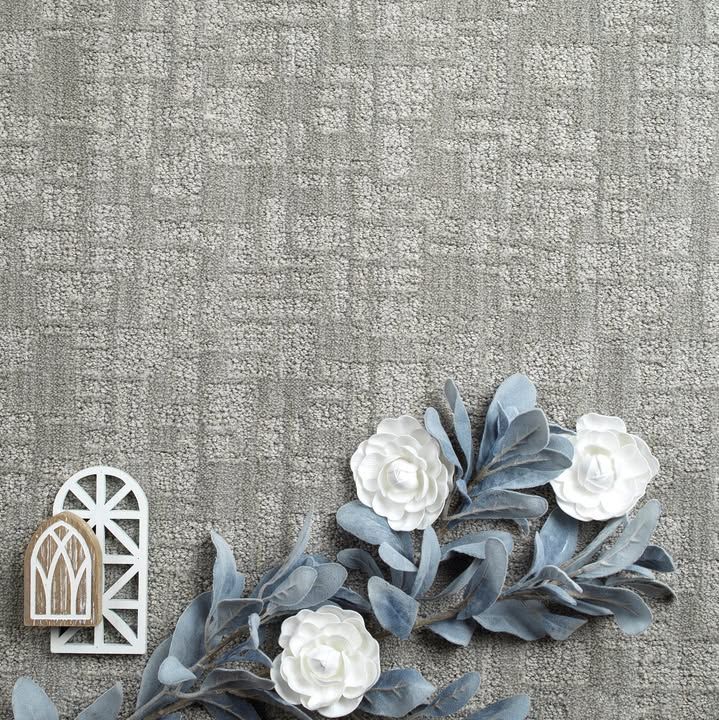 A bunch of white flowers and leaves on a gray background