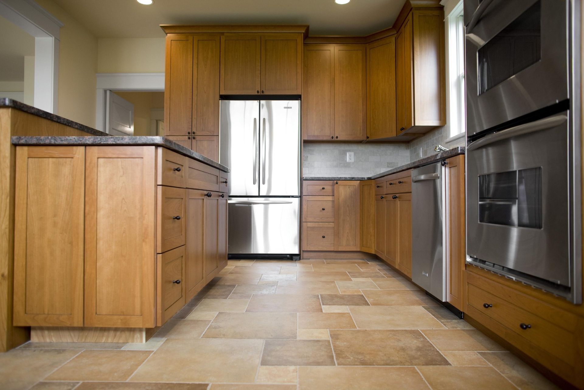 A kitchen with wooden cabinets and stainless steel appliances