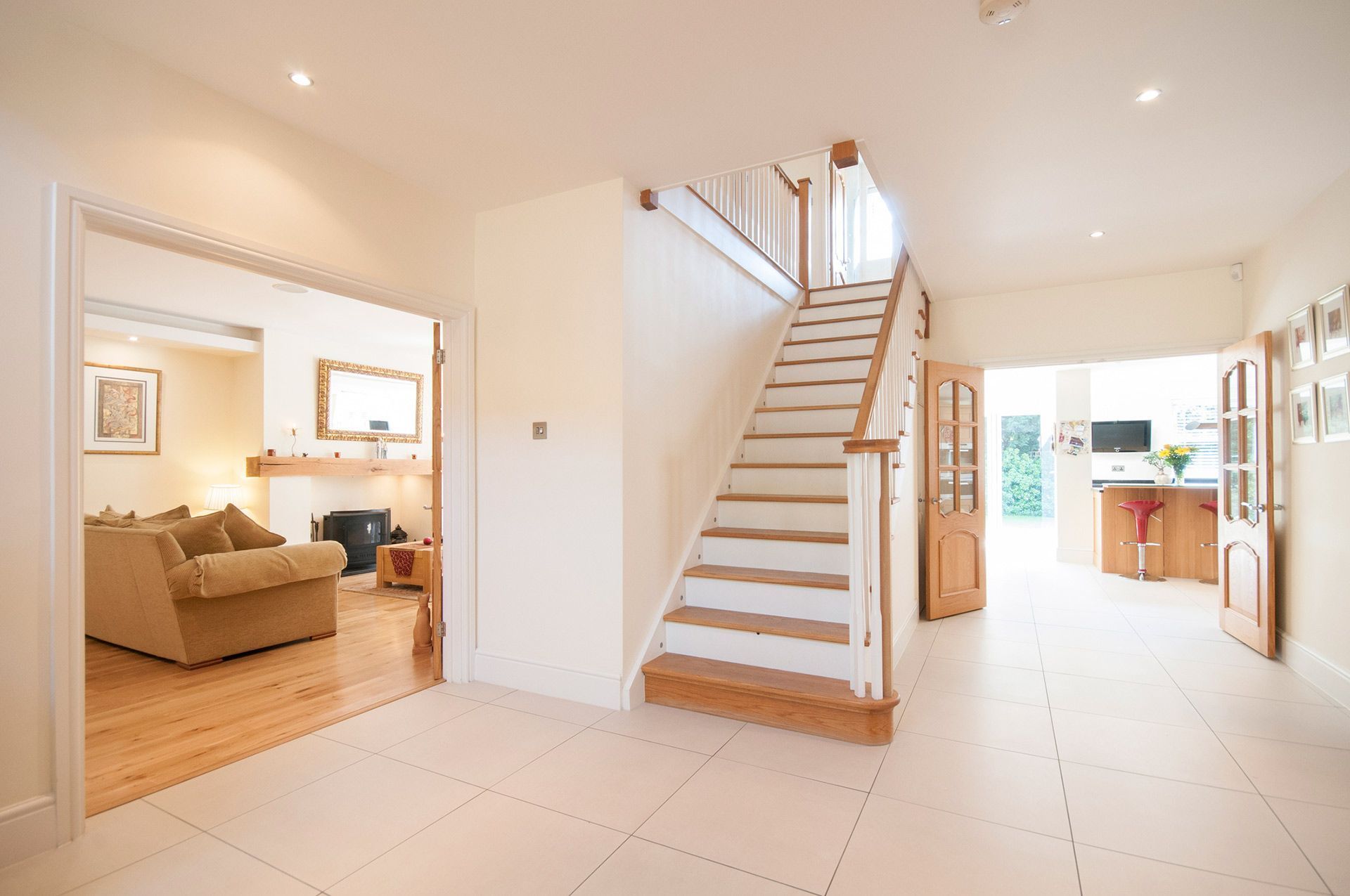 A hallway with stairs leading up to the second floor of a house