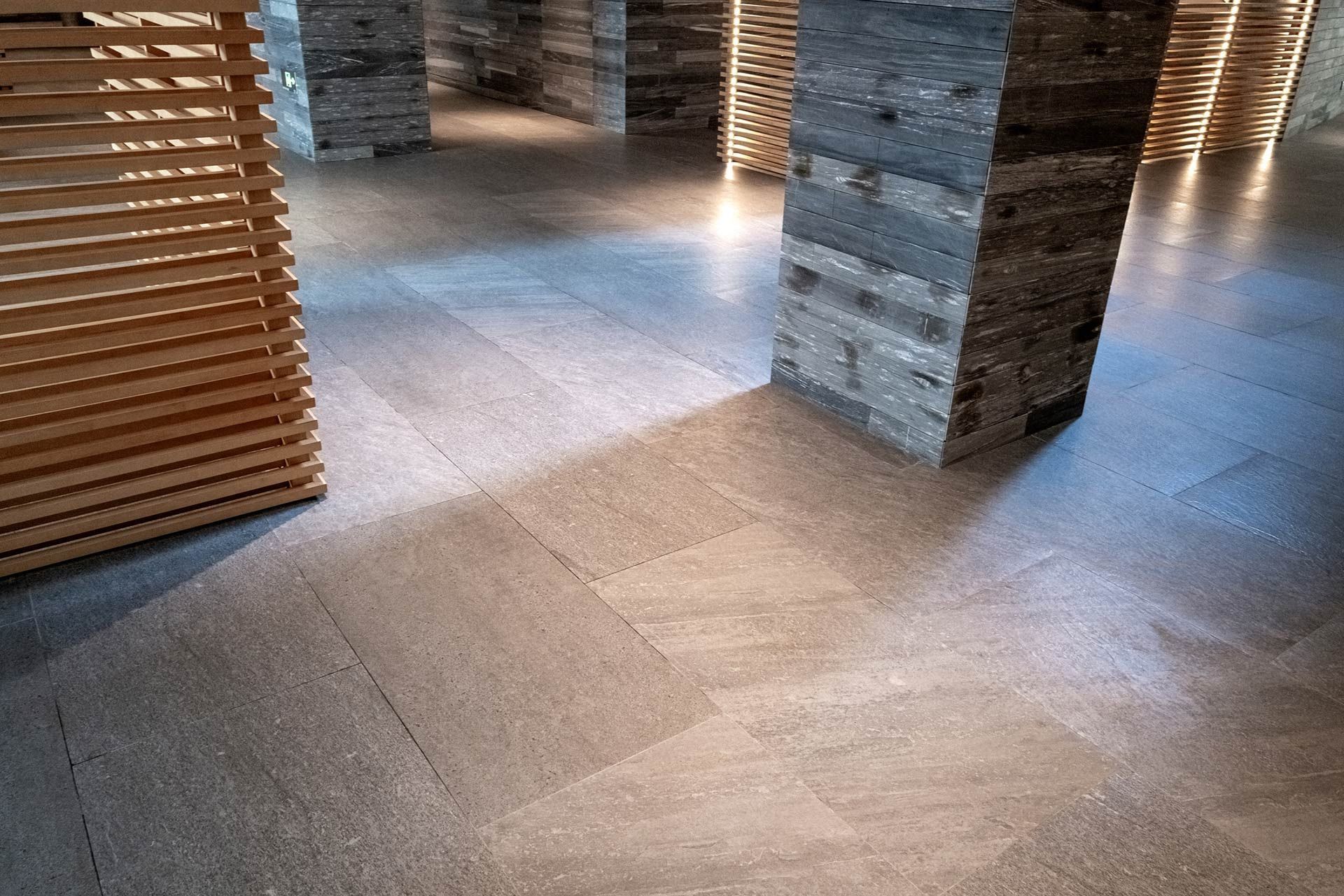 A room with brick columns and a wooden divider