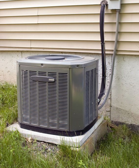 Air conditioning unit outside a beige house.