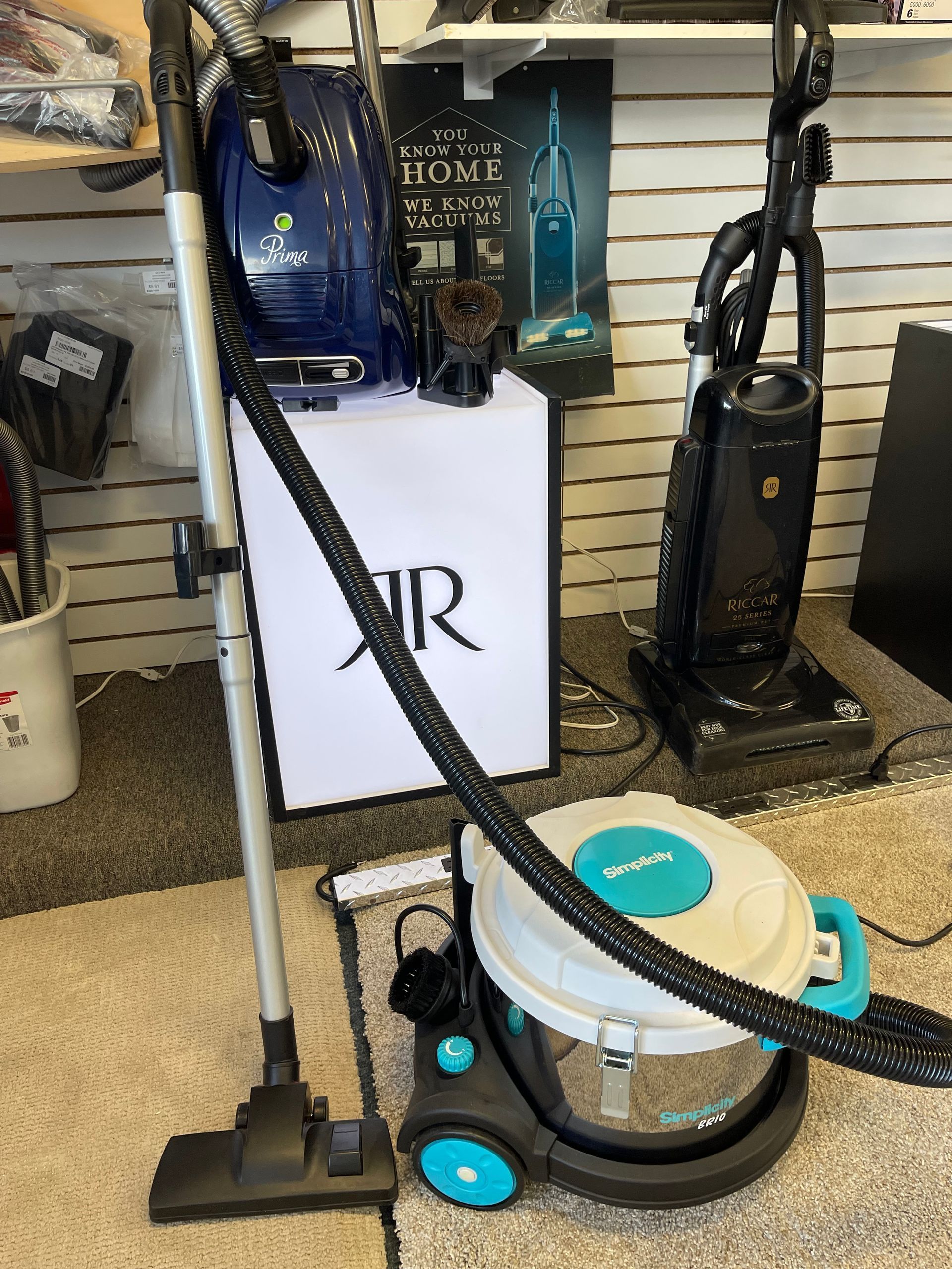 A vacuum cleaner is sitting on a carpet.
