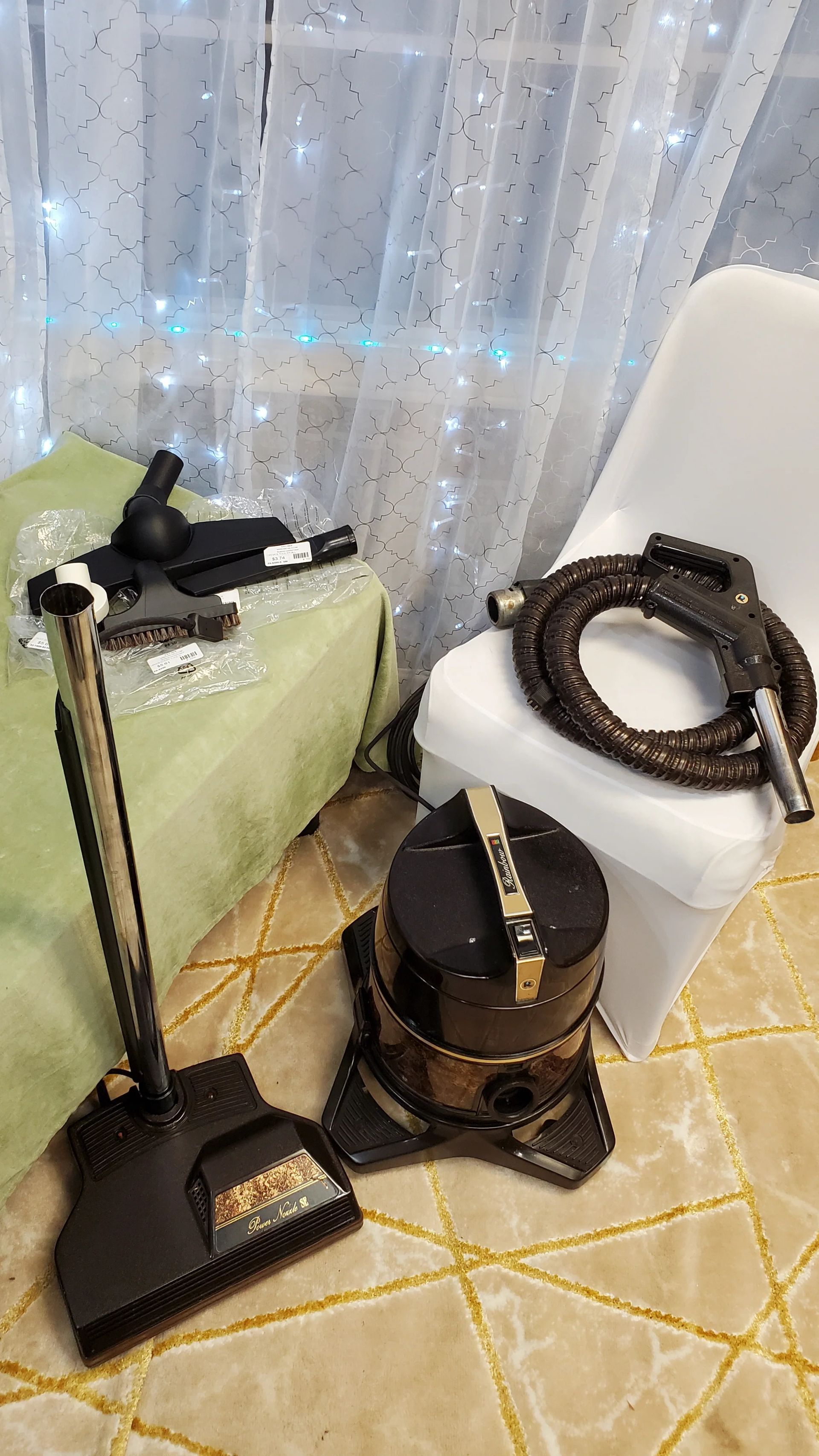 A vacuum cleaner is sitting on a rug next to a chair