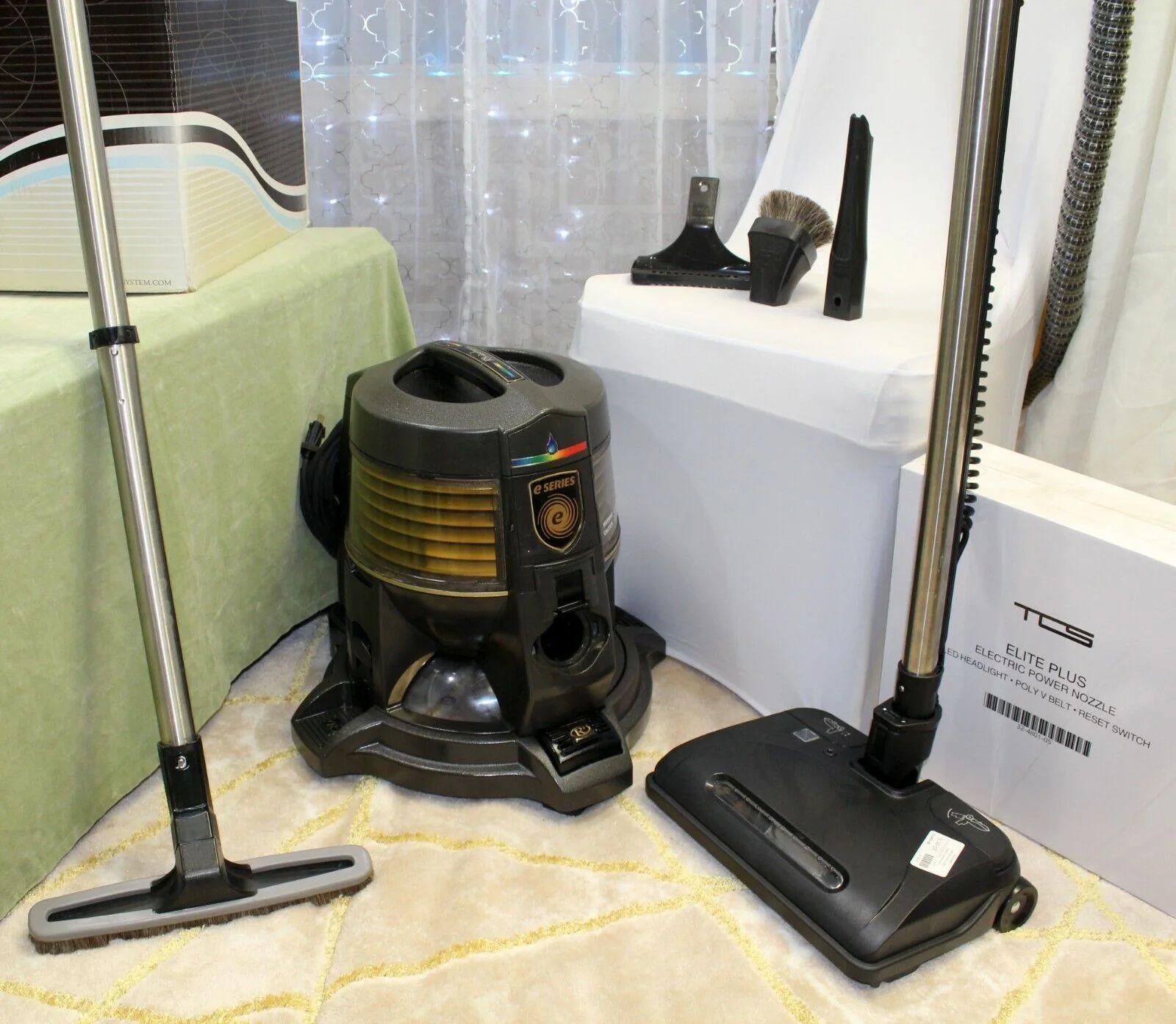 A vacuum cleaner is sitting next to a box that says washington