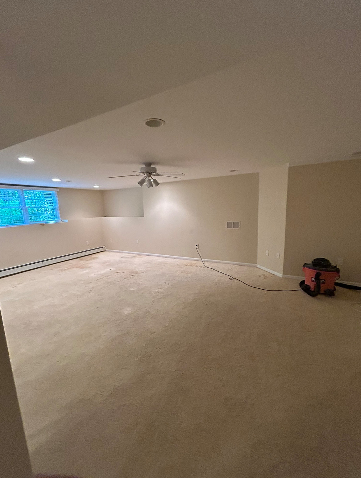 There is a vacuum cleaner in the middle of the room.