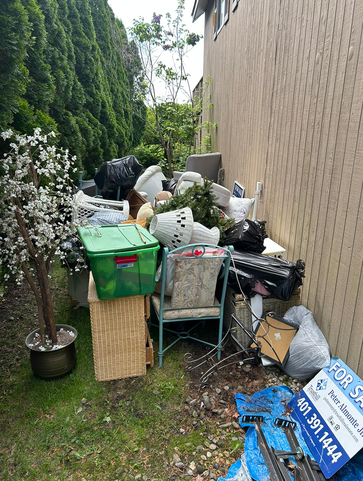 A pile of trash is sitting in front of a building.