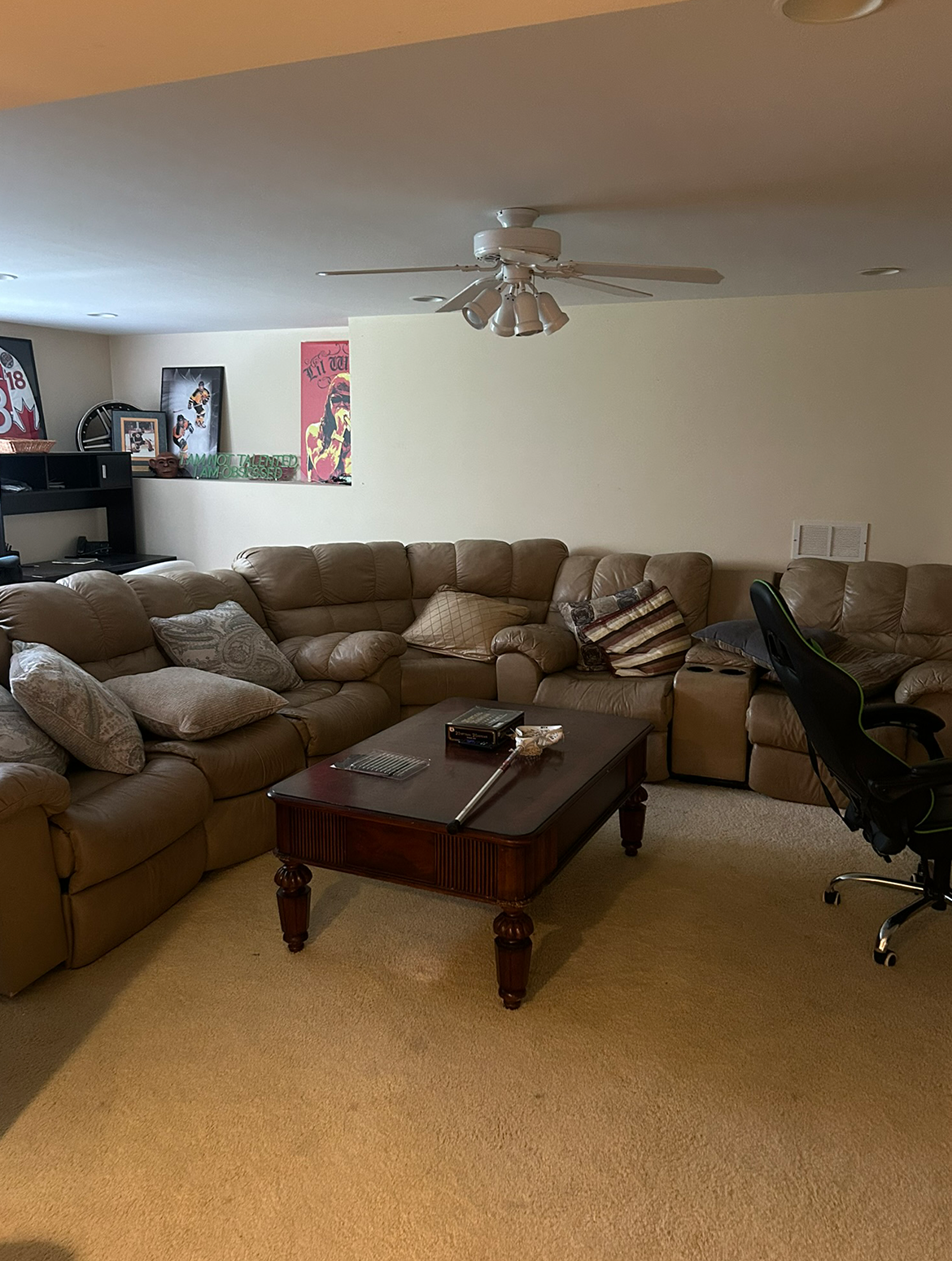 A living room with a large sectional couch and a coffee table.