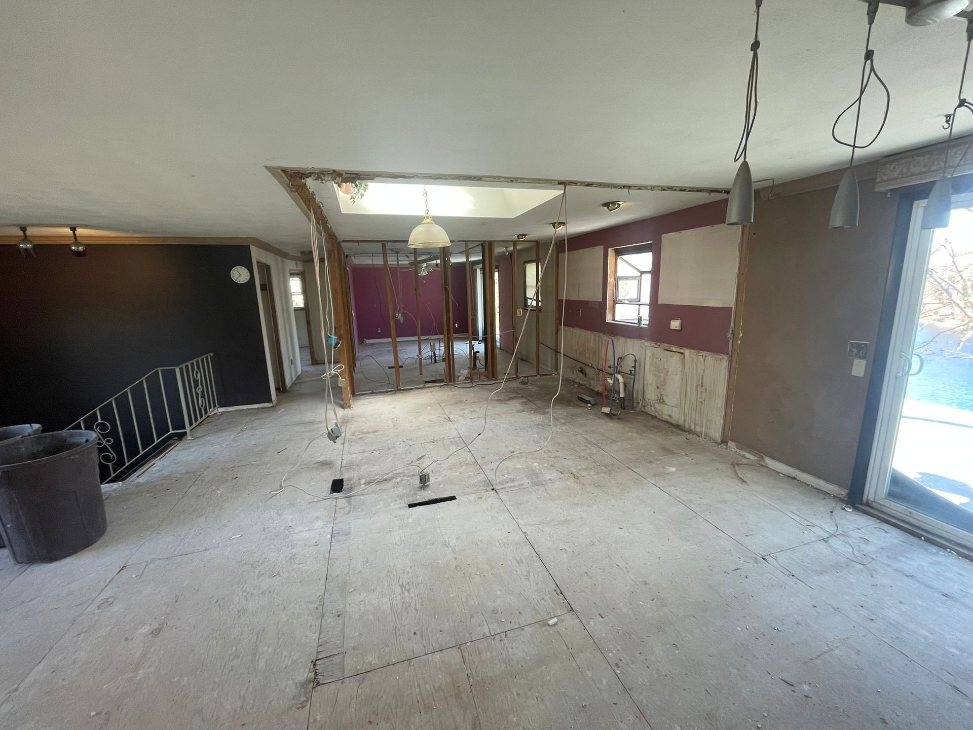 A large empty room with a staircase in the middle of it.