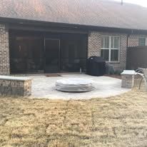 There is a fire pit in the backyard of a house.