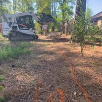 A bulldozer is sitting in the middle of a field.