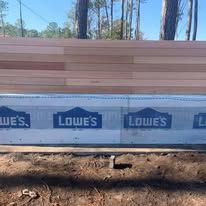 A lowe 's sign is sitting on top of a wooden bench.
